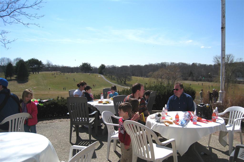 Residents Enjoying Hot Dogs and Flying Kites